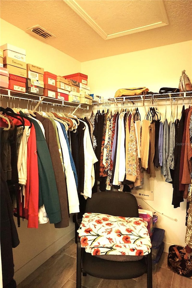 walk in closet featuring tile patterned flooring