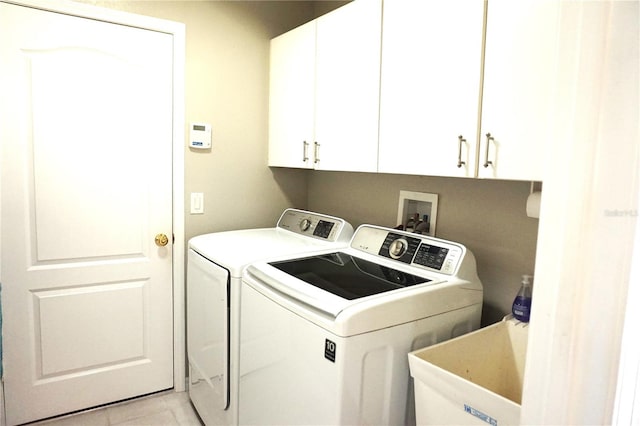 laundry room with cabinets, independent washer and dryer, sink, and light tile patterned floors