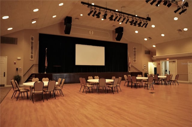 interior space with high vaulted ceiling and hardwood / wood-style flooring