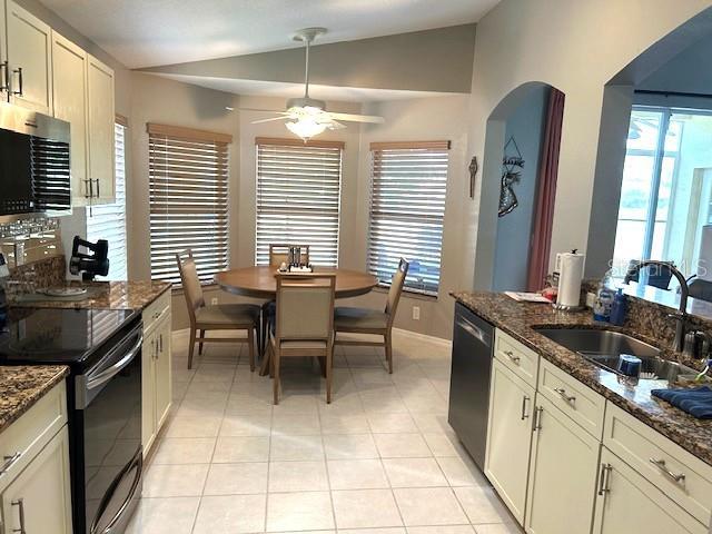11021 Edge Park Dr, Hudson, FL 34667 - kitchen featuring black electric range oven, vaulted ceiling, a sink, ceiling fan, and dishwashing machine