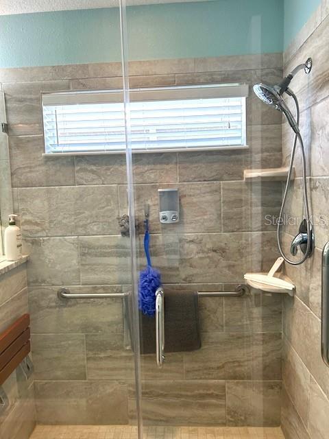 11021 Edge Park Dr, Hudson, FL 34667 - bathroom with a wealth of natural light and a stall shower