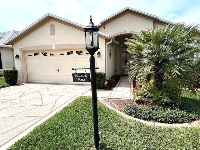 11021 Edge Park Dr, Hudson, FL 34667 - view of front of house with an attached garage, stucco siding, and driveway