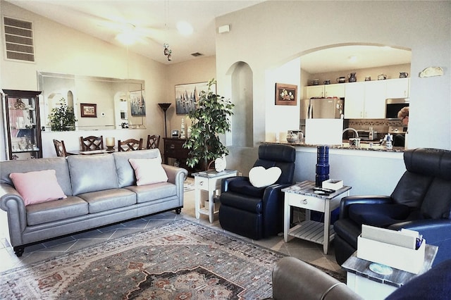11021 Edge Park Dr, Hudson, FL 34667 - tiled living room with arched walkways and lofted ceiling