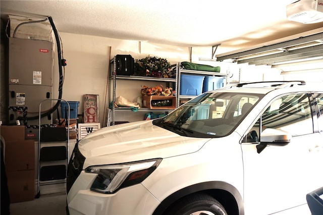 11021 Edge Park Dr, Hudson, FL 34667 - garage featuring a garage door opener and heating unit
