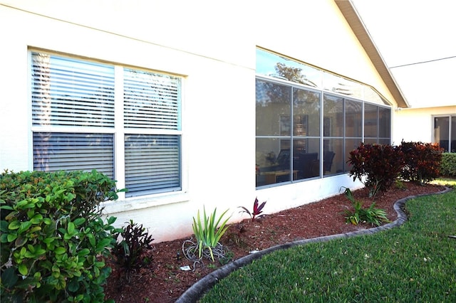 11021 Edge Park Dr, Hudson, FL 34667 - view of property exterior with stucco siding and a sunroom