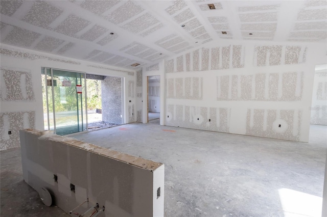 unfurnished living room with vaulted ceiling