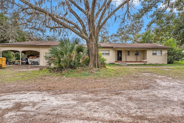 view of front of home featuring a carport and covered porch