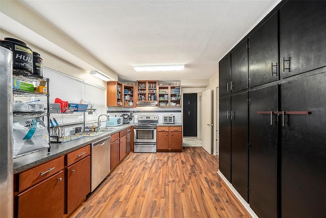 kitchen with sink, stainless steel appliances, and light wood-type flooring