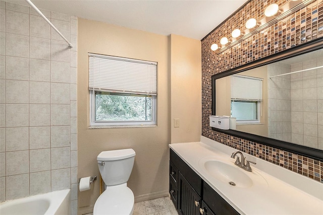 full bathroom featuring decorative backsplash, vanity, toilet, and tiled shower / bath combo