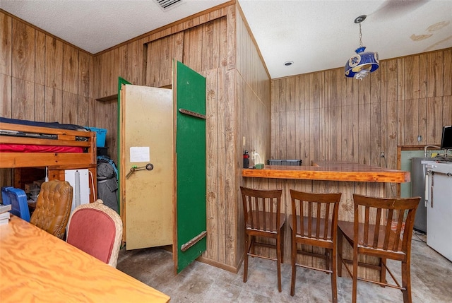 kitchen featuring wood walls