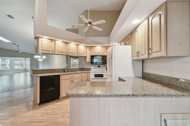 kitchen with white appliances, light stone countertops, kitchen peninsula, and light brown cabinets