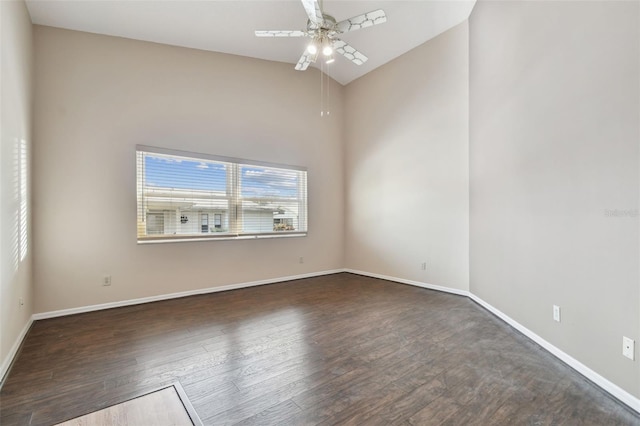 spare room featuring ceiling fan, vaulted ceiling, and dark wood-type flooring