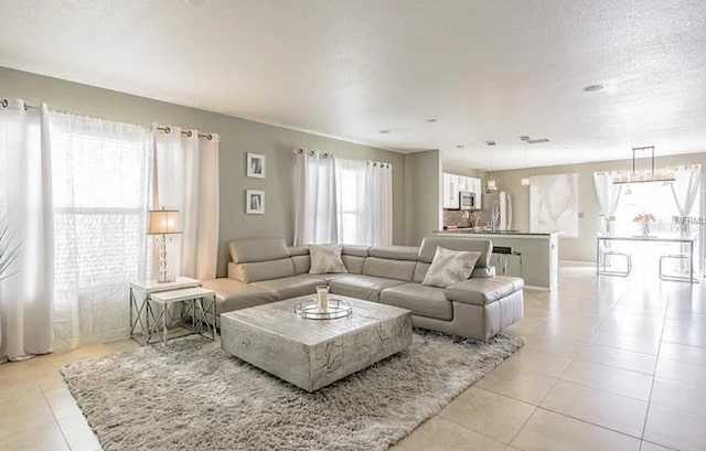 tiled living room with a textured ceiling and a wealth of natural light