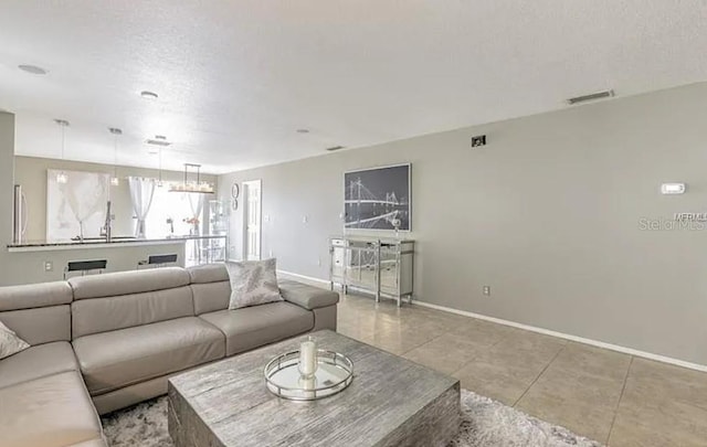 living room featuring light tile patterned floors and a textured ceiling