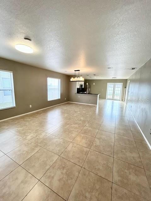 unfurnished living room featuring light tile patterned floors