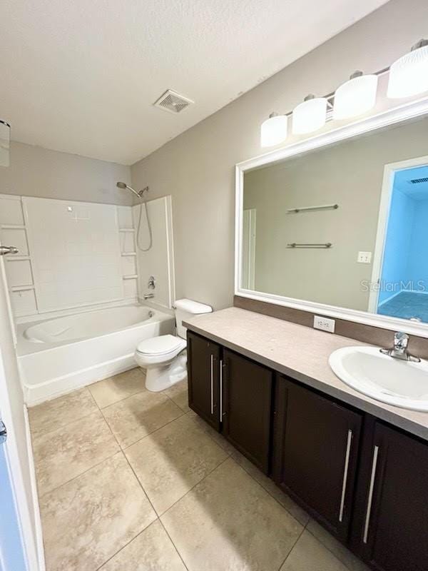 full bathroom featuring tile patterned floors, a textured ceiling, toilet, shower / tub combination, and vanity