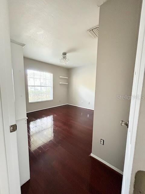 unfurnished room featuring dark wood-type flooring