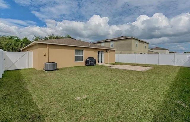 rear view of house featuring a yard