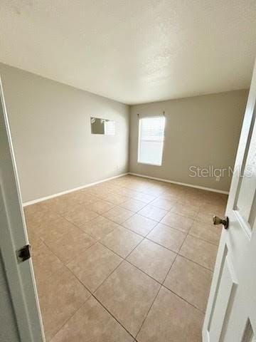 empty room with light tile patterned flooring