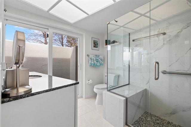 bathroom featuring vanity, toilet, an enclosed shower, and tile patterned flooring