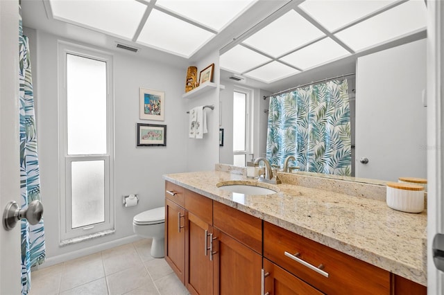 bathroom with vanity, tile patterned floors, and toilet