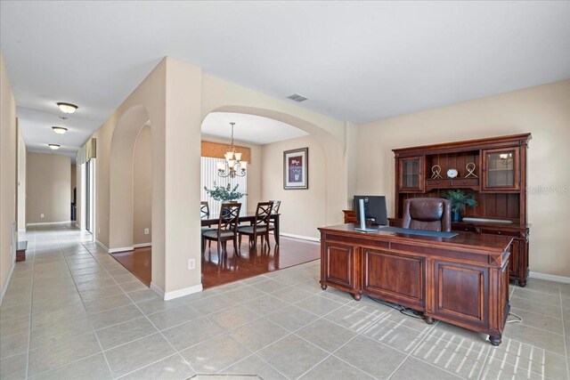 tiled home office with a notable chandelier