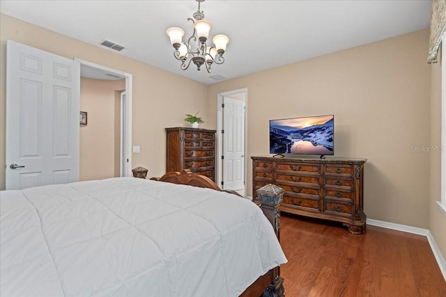 bedroom with wood-type flooring and a chandelier