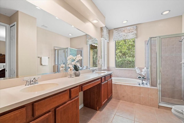 bathroom with independent shower and bath, tile patterned floors, and vanity