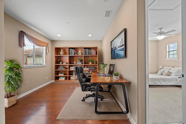 home office featuring hardwood / wood-style floors, plenty of natural light, and ceiling fan