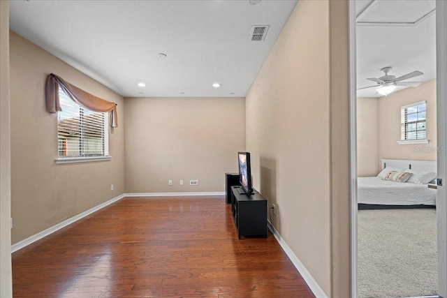 living room with plenty of natural light, hardwood / wood-style flooring, and ceiling fan