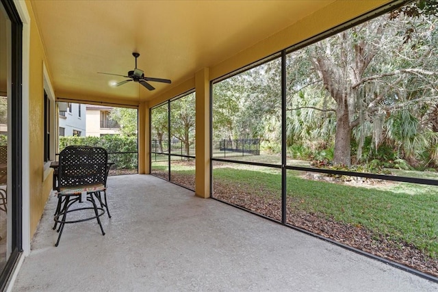 unfurnished sunroom featuring ceiling fan