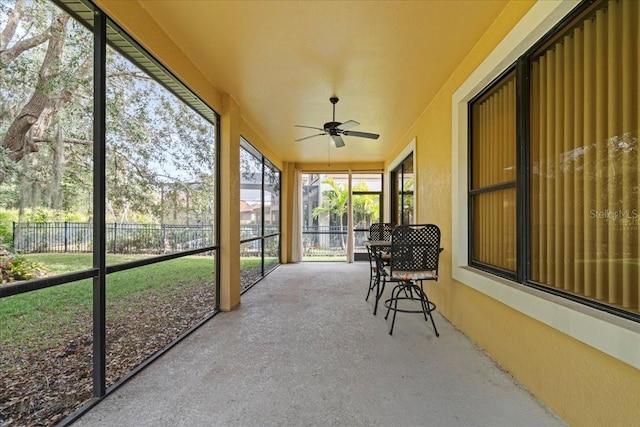 sunroom featuring ceiling fan