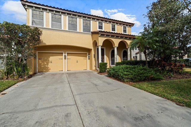 mediterranean / spanish home featuring a garage