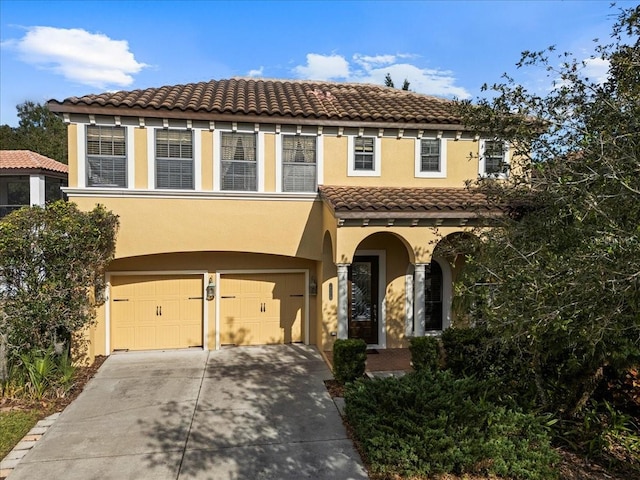 mediterranean / spanish-style house featuring a garage