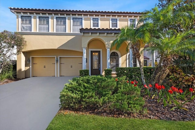 20314 Chestnut Grove Dr, Tampa, FL 33647 - mediterranean / spanish-style home with a garage, driveway, a tile roof, and stucco siding