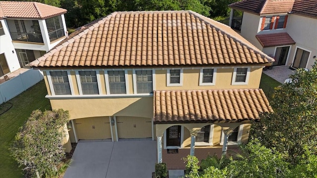20314 Chestnut Grove Dr, Tampa, FL 33647 - view of front of property with fence, a garage, stucco siding, a tiled roof, and driveway
