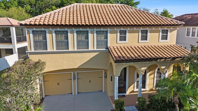20314 Chestnut Grove Dr, Tampa, FL 33647 - mediterranean / spanish house featuring an attached garage, stucco siding, a tiled roof, and driveway