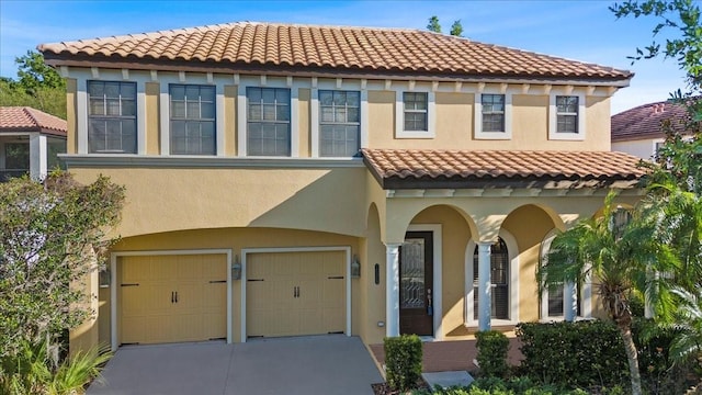 20314 Chestnut Grove Dr, Tampa, FL 33647 - mediterranean / spanish-style house with concrete driveway, an attached garage, stucco siding, and a tile roof