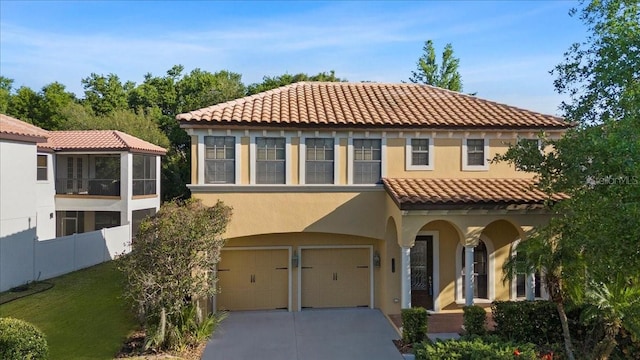 20314 Chestnut Grove Dr, Tampa, FL 33647 - mediterranean / spanish house with fence, an attached garage, a tile roof, stucco siding, and driveway
