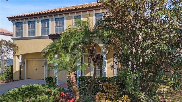 20314 Chestnut Grove Dr, Tampa, FL 33647 - mediterranean / spanish house with a tiled roof, an attached garage, driveway, and stucco siding