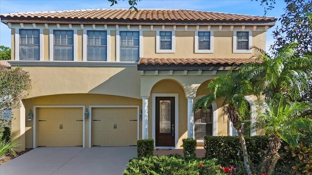20314 Chestnut Grove Dr, Tampa, FL 33647 - mediterranean / spanish house featuring a tile roof, an attached garage, stucco siding, and driveway