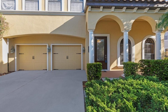 20314 Chestnut Grove Dr, Tampa, FL 33647 - view of exterior entry with an attached garage, stucco siding, and concrete driveway