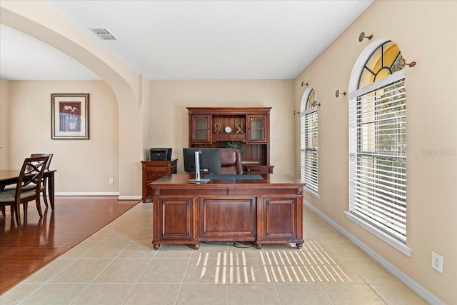20314 Chestnut Grove Dr, Tampa, FL 33647 - office area featuring visible vents, arched walkways, baseboards, and a healthy amount of sunlight
