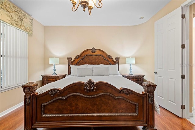 20314 Chestnut Grove Dr, Tampa, FL 33647 - bedroom featuring baseboards, a notable chandelier, and light wood-style floors