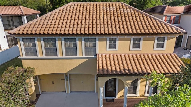 20314 Chestnut Grove Dr, Tampa, FL 33647 - view of front facade with a tile roof, fence, concrete driveway, an attached garage, and stucco siding