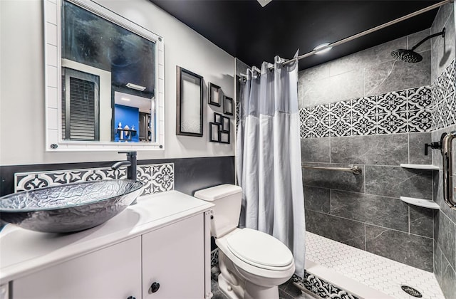 bathroom featuring vanity, curtained shower, and toilet