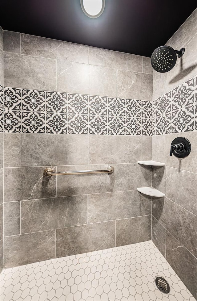 bathroom with a tile shower