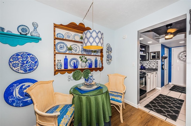 dining area featuring ceiling fan and light wood-type flooring