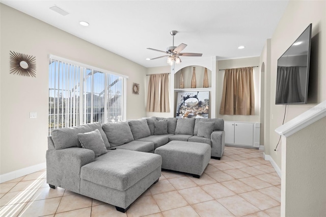 living room featuring light tile patterned floors and ceiling fan