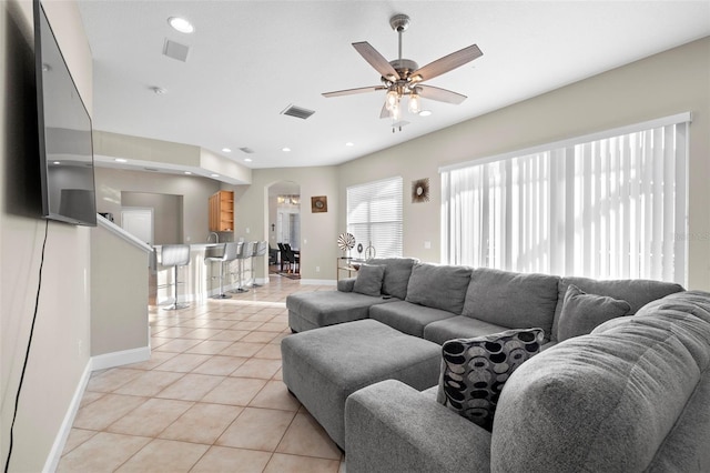 living room with ceiling fan and light tile patterned floors